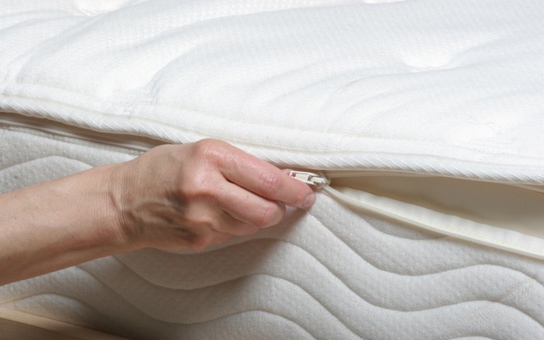 organic-cotton-cover-zipper Close up view of latex mattress with organic cover being unzipped.